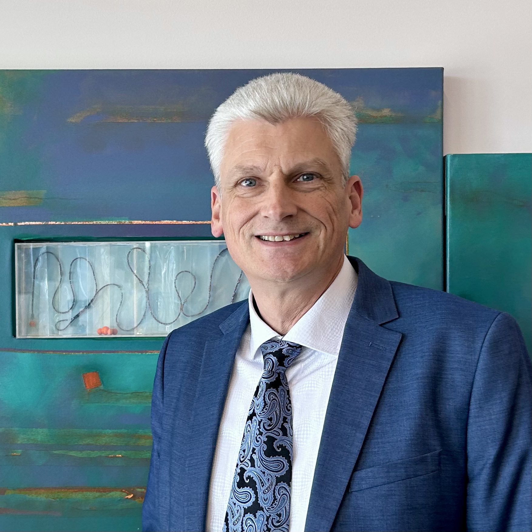 Marc, founder of Pockkit, smiling in a blue suit